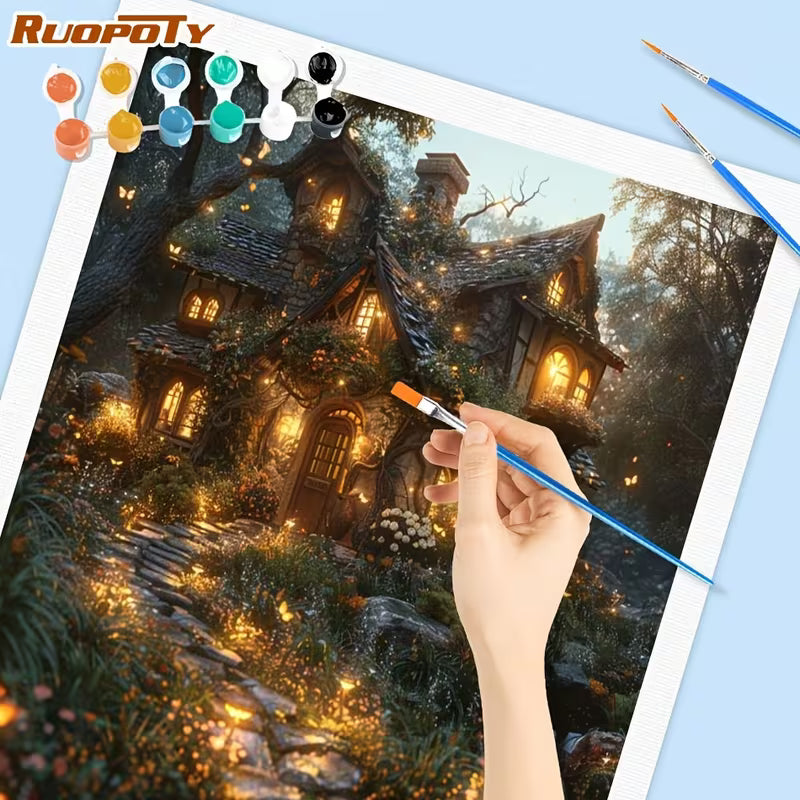 Картина по номера Ruopoty с вълшебна къщичка в гората, ръка рисува с четка, видими бои и четки около платното